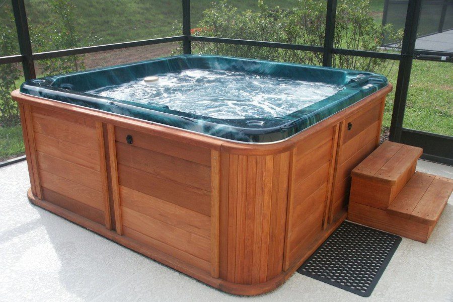 A hot tub is shown in the middle of a patio.