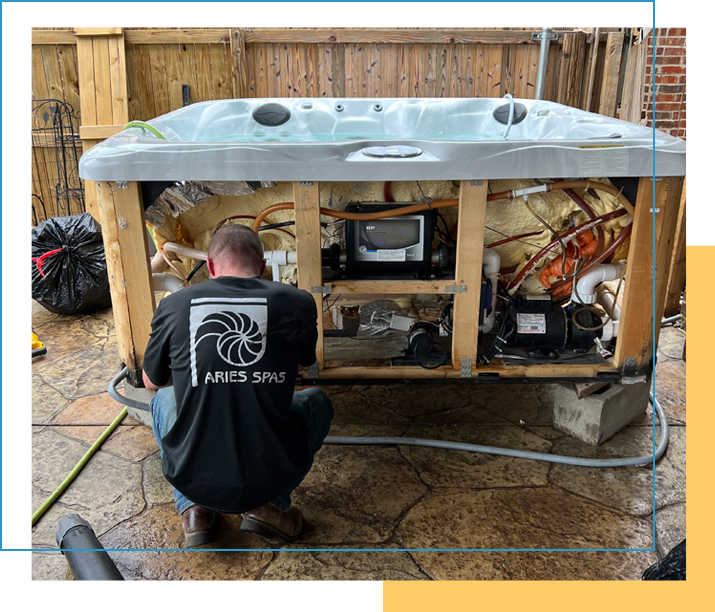 A man working on an outdoor hot tub.