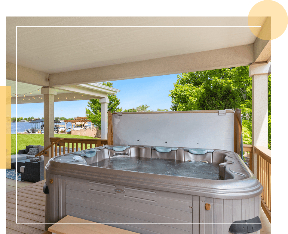 A hot tub is shown on the deck of a house.